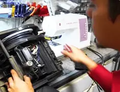 Vacuum repair technician servicing internal components on a workbench in Jacksonville, FL